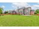 Lush backyard features a gazebo, deck, basketball hoop and wooden fence at 1649 Woodstock Dr, Brownsburg, IN 46112