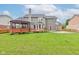Expansive backyard features a gazebo, deck, mature trees, and ample green space for outdoor activities at 1649 Woodstock Dr, Brownsburg, IN 46112