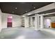 Large basement area with gray painted floor, dark ceiling and ample open space at 1649 Woodstock Dr, Brownsburg, IN 46112