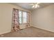 The bedroom has natural light and a floral curtain at 1649 Woodstock Dr, Brownsburg, IN 46112