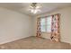 This bedroom has a ceiling fan and curtains framing the window at 1649 Woodstock Dr, Brownsburg, IN 46112