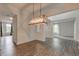 Spacious dining room with wood floors, wainscotting, and view to living room at 1649 Woodstock Dr, Brownsburg, IN 46112