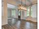 Dining room with luxury vinyl plank floors, wainscotting, pendant light, and windows at 1649 Woodstock Dr, Brownsburg, IN 46112
