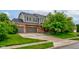 Inviting two-story home with attached two-car garage, well-manicured lawn and mature trees at 1649 Woodstock Dr, Brownsburg, IN 46112