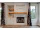 Living room fireplace featuring built-in shelving and wooden mantle at 1649 Woodstock Dr, Brownsburg, IN 46112