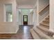 Elegant foyer showcasing hardwood floors, staircase, and views into adjoining rooms at 1649 Woodstock Dr, Brownsburg, IN 46112