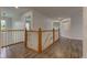 Upstairs hallway with wood floors and white railings at 1649 Woodstock Dr, Brownsburg, IN 46112