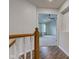 Hallway featuring a wooden railing and vinyl floors at 1649 Woodstock Dr, Brownsburg, IN 46112