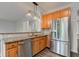 Modern kitchen with stainless steel refrigerator and granite countertops at 1649 Woodstock Dr, Brownsburg, IN 46112