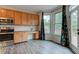 Open kitchen featuring wooden cabinets, granite countertops, and stainless steel appliances at 1649 Woodstock Dr, Brownsburg, IN 46112