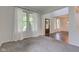 Bright living room with carpet, windows, and doorway leading to another room at 1649 Woodstock Dr, Brownsburg, IN 46112
