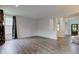 Open living room with hardwood floors and access to the front entrance at 1649 Woodstock Dr, Brownsburg, IN 46112