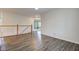 Open living room featuring vinyl floors and a wooden railing at 1649 Woodstock Dr, Brownsburg, IN 46112