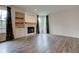 Cozy living room featuring a fireplace with built-in shelving and natural light at 1649 Woodstock Dr, Brownsburg, IN 46112