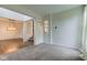Bright living room with carpet, view to the dining area and staircase at 1649 Woodstock Dr, Brownsburg, IN 46112