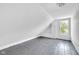 Bright attic room with angled ceilings and wood floors, offering flexible space to customize as needed at 19 E Regent St, Indianapolis, IN 46225