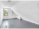 Cozy attic space with pitched ceilings, wood flooring, and a window, creating a charming and adaptable area at 19 E Regent St, Indianapolis, IN 46225