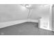Unfinished attic space with gray-painted wood floors, offering potential for storage or customization at 19 E Regent St, Indianapolis, IN 46225