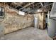 Unfinished basement with brick and cement walls, exposed utilities, offering a chance to customize the space at 19 E Regent St, Indianapolis, IN 46225