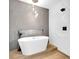 Spa bathroom with a freestanding tub, stylish tile, and a contemporary lighting fixture at 19 E Regent St, Indianapolis, IN 46225