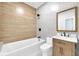 Modern bathroom featuring a tub with shower, vanity with storage, and stylish finishes at 19 E Regent St, Indianapolis, IN 46225