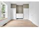 A spacious bedroom offers three doors and a built-in dresser with blonde floors at 19 E Regent St, Indianapolis, IN 46225