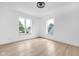 A large empty room has blonde floors and bright windows for natural lighting at 19 E Regent St, Indianapolis, IN 46225