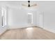 Bright bedroom with hardwood floors and a ceiling fan and two windows for light at 19 E Regent St, Indianapolis, IN 46225