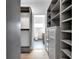 Custom closet features plenty of shelving and drawer space, plus a view into an en suite bathroom at 19 E Regent St, Indianapolis, IN 46225