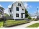 Charming two-story home with a black fence, black framed windows, and a well-manicured front yard at 19 E Regent St, Indianapolis, IN 46225