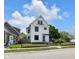 Charming two-story home with a black fence, black framed windows, and a well-manicured front yard at 19 E Regent St, Indianapolis, IN 46225