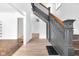 Open foyer with gray staircase and hardwood floors at 19 E Regent St, Indianapolis, IN 46225