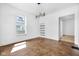 Bright living room with herringbone floors, built-in shelves, and a stylish, modern light fixture at 19 E Regent St, Indianapolis, IN 46225
