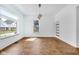 Bright living room with stylish light fixture and hardwood floors at 19 E Regent St, Indianapolis, IN 46225