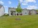 Spacious backyard with a covered patio and outdoor furniture, perfect for relaxation and outdoor gatherings at 19657 Astoria Ave, Sheridan, IN 46069