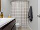Bright bathroom featuring tile floors, wooden vanity, and a shower with curtain at 19657 Astoria Ave, Sheridan, IN 46069