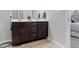 Bathroom featuring a double vanity with dark wood cabinets, white countertop and view of the bedroom at 19657 Astoria Ave, Sheridan, IN 46069