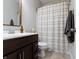 Well-lit bathroom featuring tile floors, wooden vanity, and a shower with curtain at 19657 Astoria Ave, Sheridan, IN 46069