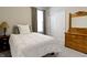 Cozy bedroom featuring a neutral color palette, comfortable bed, and a wooden dresser at 19657 Astoria Ave, Sheridan, IN 46069