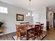 Inviting dining room with a wooden table, chandelier, and view into the kitchen at 19657 Astoria Ave, Sheridan, IN 46069
