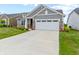 Charming two-story home with stone accents, manicured lawn, and a concrete driveway leading to a two-car garage at 19657 Astoria Ave, Sheridan, IN 46069