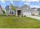 Attractive home features a well-manicured lawn, a two-car garage, and a tasteful stone facade at 19657 Astoria Ave, Sheridan, IN 46069