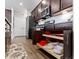 Modern kitchen boasts dark cabinets with stainless appliances and pull-out shelving at 19657 Astoria Ave, Sheridan, IN 46069