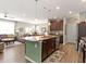 Open-concept kitchen with island, stainless steel appliances and view of living area at 19657 Astoria Ave, Sheridan, IN 46069