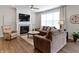 Cozy living room features a fireplace, ceiling fan, and large window at 19657 Astoria Ave, Sheridan, IN 46069