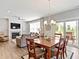 Spacious living room with fireplace, dining area, and access to outdoor patio at 19657 Astoria Ave, Sheridan, IN 46069