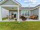 Covered patio with comfortable outdoor seating, perfect for relaxing and entertaining with a beautiful lawn at 19657 Astoria Ave, Sheridan, IN 46069