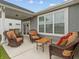 Comfortable covered patio with wicker furniture, perfect for outdoor relaxation and entertaining at 19657 Astoria Ave, Sheridan, IN 46069