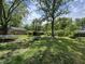 Spacious backyard featuring a shed, mature trees, a tire swing and trampoline at 2015 Rosewood Dr, Anderson, IN 46011