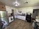 Functional kitchen with white cabinets, a stainless steel refrigerator, and essential appliances at 2015 Rosewood Dr, Anderson, IN 46011
